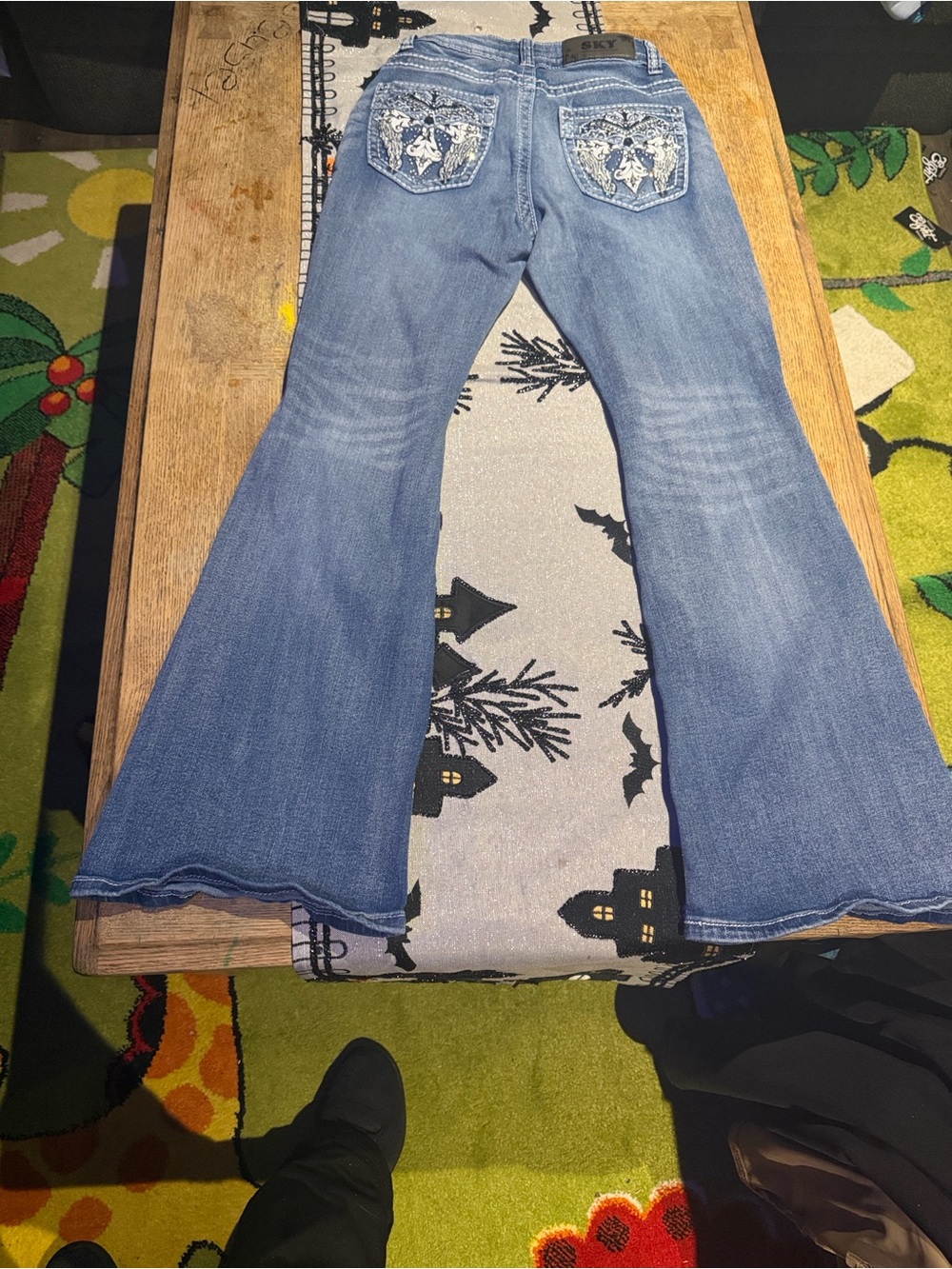 Sky Denim Wide-Leg Flare Jeans in Blue with Embroidered Pockets